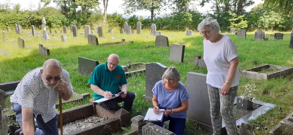 group transcribing gravestones